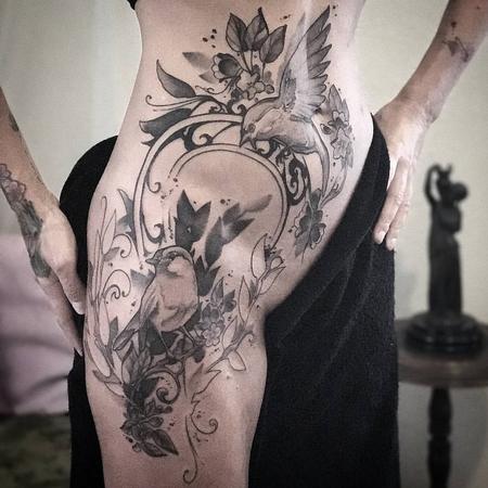 Tattoos - Birds, flowers, vines with Art Nouveau filigree on model's hip. Black and grey. - 130519